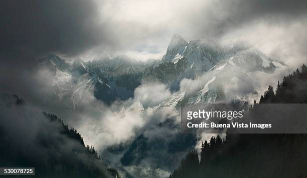 mountains with clouds and fog in winter - nebbia foto e immagini stock