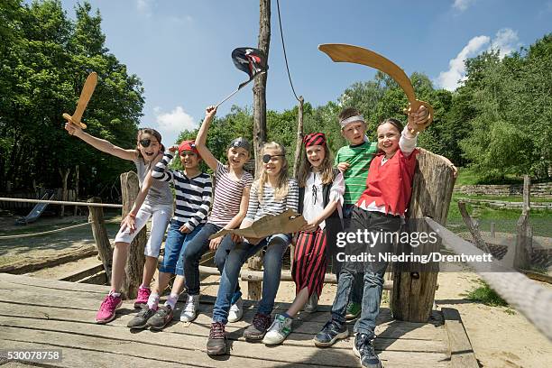 group of children playing on a pirate ship in adventure playground, bavaria, germany - fake of indian girls stock pictures, royalty-free photos & images