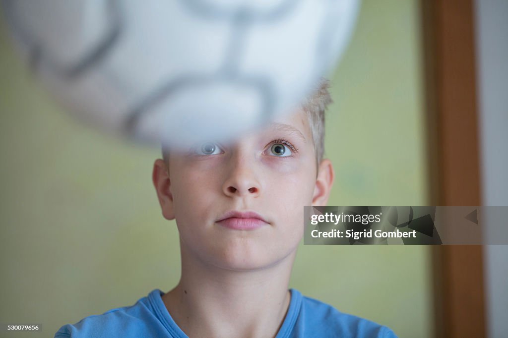 Boy playing with football, Freiburg im Breisgau, Baden-W��rttemberg, Germany