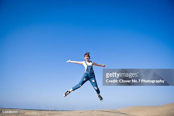 energetic girl jumping - taiwanesischer abstammung stock-fotos und bilder