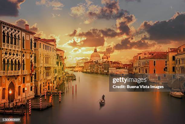 gondola in the grand canal at sunset - venice stock pictures, royalty-free photos & images