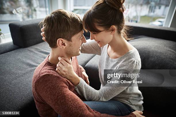 happy couple embracing at home - happy couple cuddle stockfoto's en -beelden