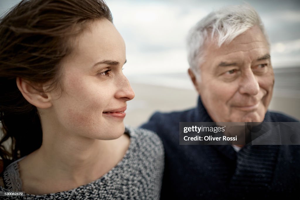 Senior man with adult daughter on the beach