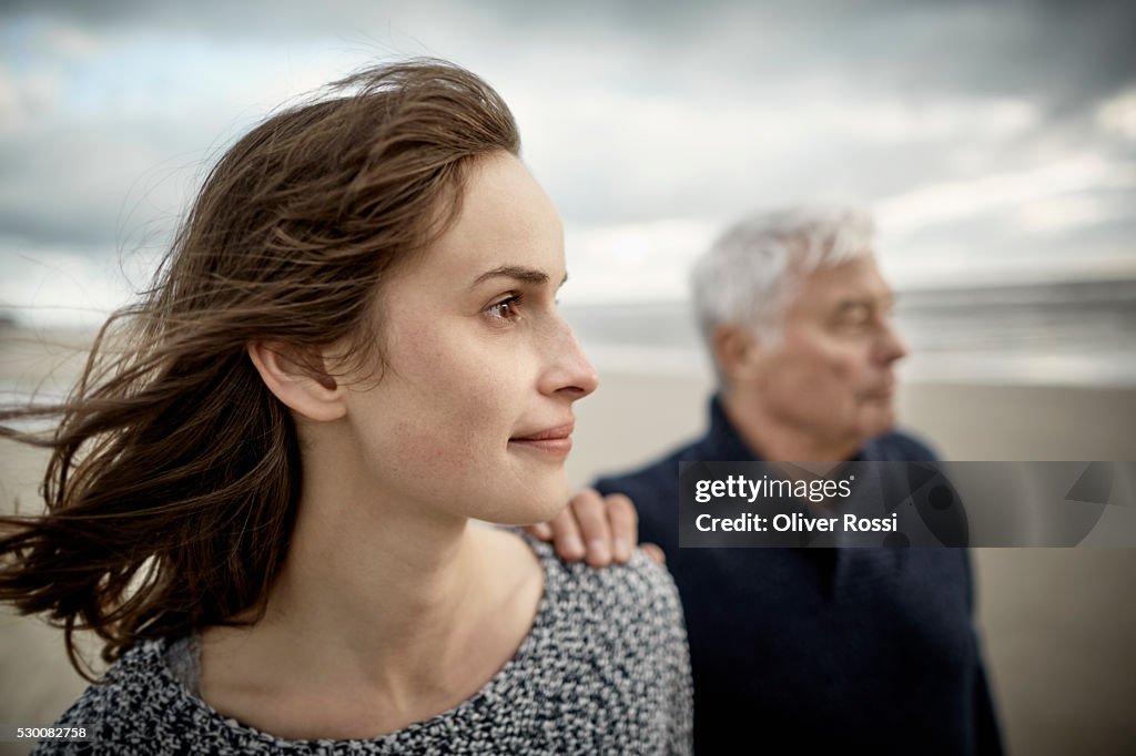 Senior man with adult daughter on the beach