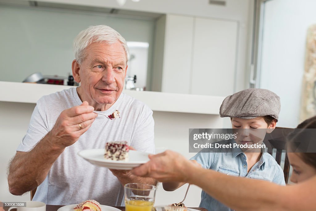 Extended family at table eating cake