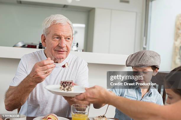 extended family at table eating cake - man eating pie stock pictures, royalty-free photos & images