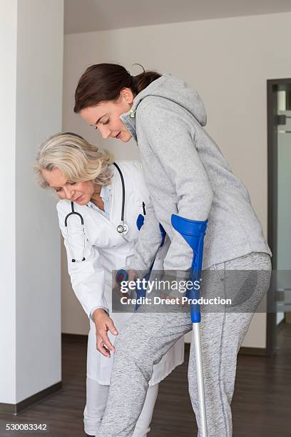 patient with crutches prcticing to walk - acupuncture elderly stock pictures, royalty-free photos & images