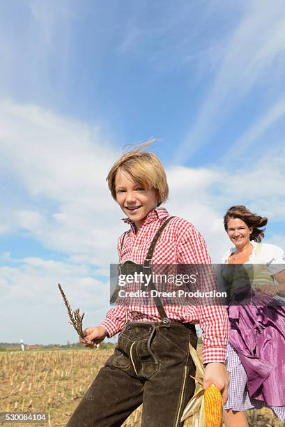 mother and son running in cornfield, bavaria, germany - knickers photos et images de collection
