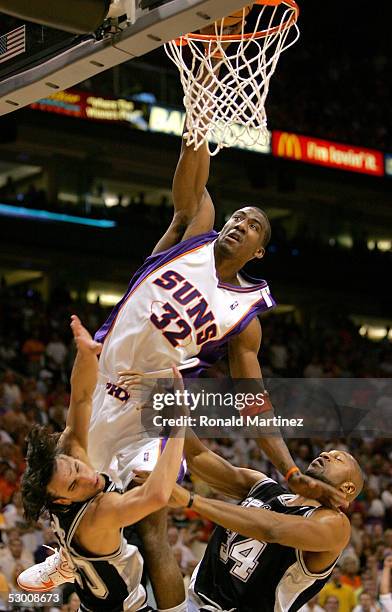 Amare Stoudemire of the Phoenix Suns goes up for a dunk over Manu Ginobili and Tony Massenburg of the San Antonio Spurs in Game five of the Western...