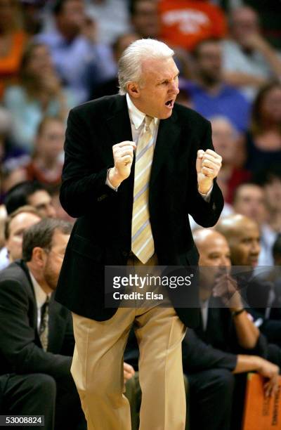 Head coach Gregg Popovich of the San Antonio Spurs cheers for his team from the sidelines against the Phoenix Suns in Game five of the Western...