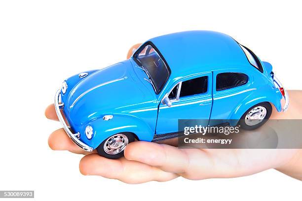 volkswagen toy beetle holding the hands of child - beetle isolated stock pictures, royalty-free photos & images