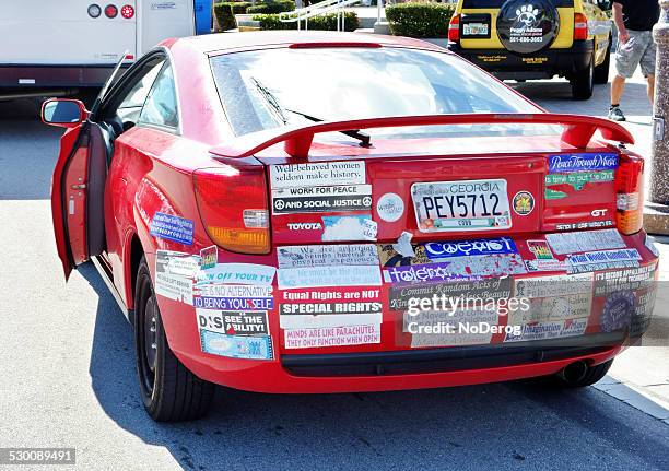 car with socially responsible bumper stickers - bumper sticker stock pictures, royalty-free photos & images