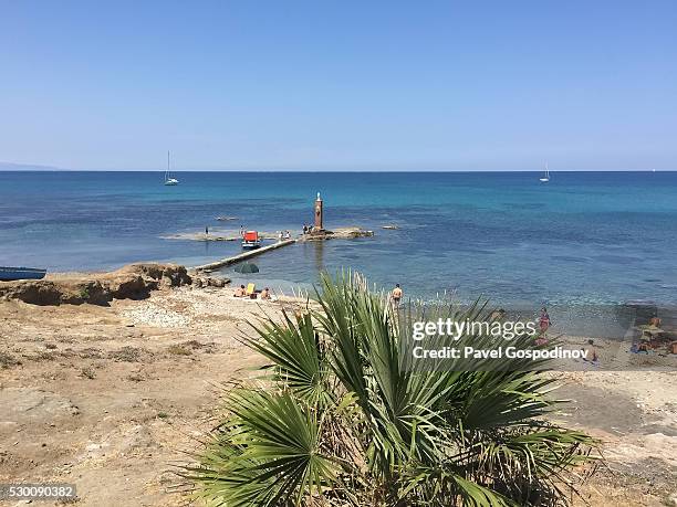 beach and a small pier in portopalo di capo passero, sicily - portopalo di capo passero stock pictures, royalty-free photos & images