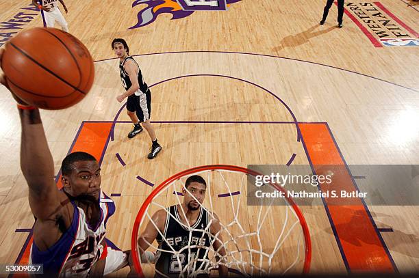 Amare Stoudemire of the Phoenix Suns goes for the slam as Tim Duncan of the San Antonio Spurs watches in Game five of the Western Conference Finals...