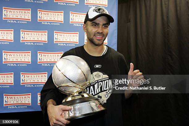 Tony Parker of the San Antonio Spurs holds the Western Conference Trophy while celebrating their win of the Western Conference Finals during the 2005...