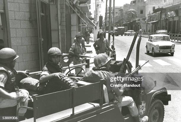 In this handout photo from the GPO, an Israeli army patrol passes along the city's main shopping street some four years after the 1967 Six-Day War,...