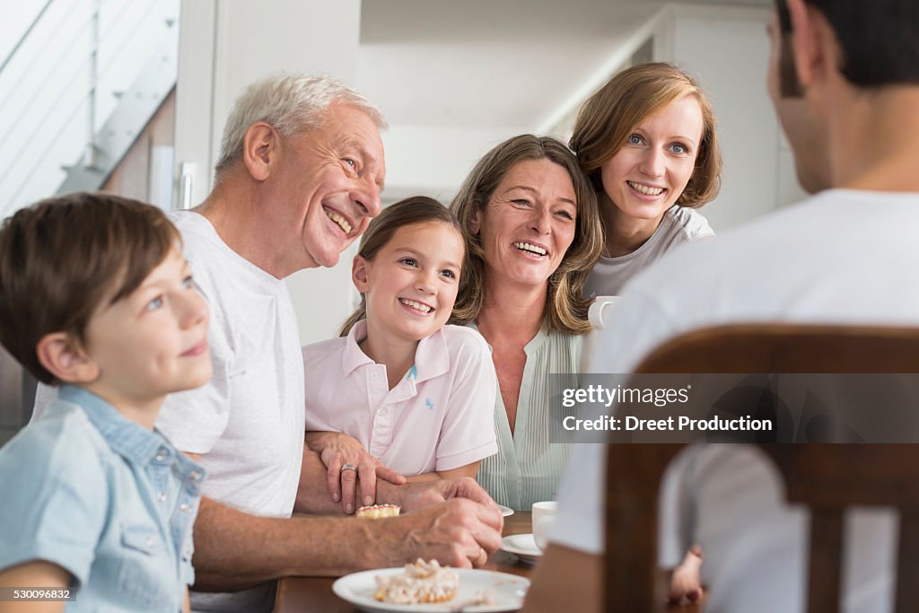 Extended family at table eating cake