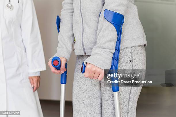 patient with crutches prcticing to walk - acupuncture elderly stock pictures, royalty-free photos & images