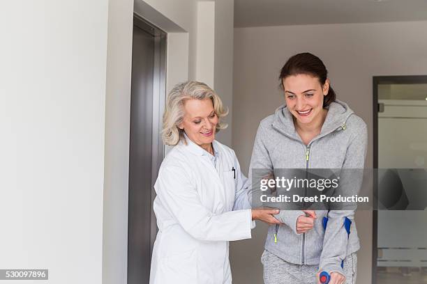 patient with crutches prcticing to walk - acupuncture elderly stock pictures, royalty-free photos & images