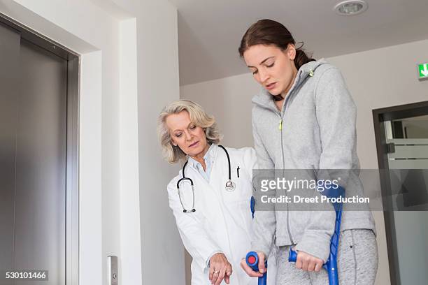 patient with crutches prcticing to walk - acupuncture elderly stock pictures, royalty-free photos & images