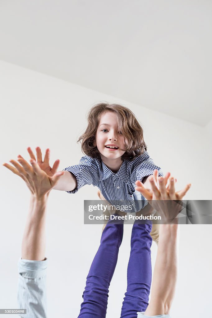 Mother balancing her daughter on her feet