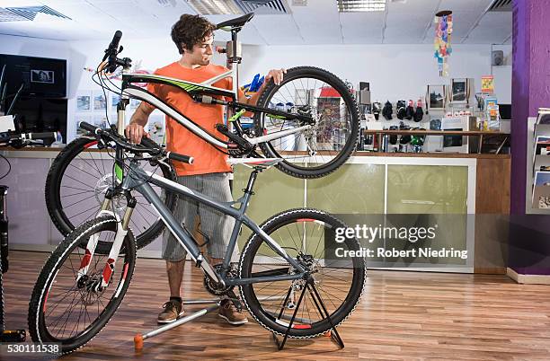 young man buying bicycle, bavaria, germany - shopping with bike stock-fotos und bilder