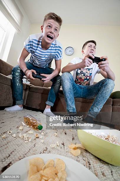 two teenage boys playing video game - faze rug stock pictures, royalty-free photos & images