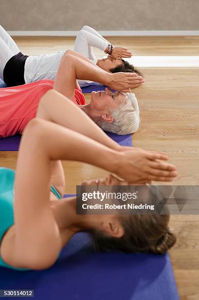 close up three women fitness meditation yoga - supino foto e immagini stock