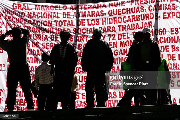 Protesters stand together as they look at a political manifesto June 2, 2005 in La Paz, Bolivia. Demonstrators from around the country have converged...