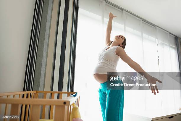 young pregnant woman happy dancing posing - belly dancer fotografías e imágenes de stock