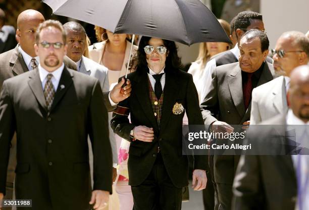 Singer Michael Jackson and his father Joseph Jackson depart the courthouse after listening to closing arguements in his child molestation trial at...