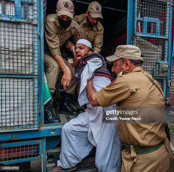 Indian Police detain a disabled member of All Jammu and Kashmir Handicapped Association shout anti government slogans during an anti government...