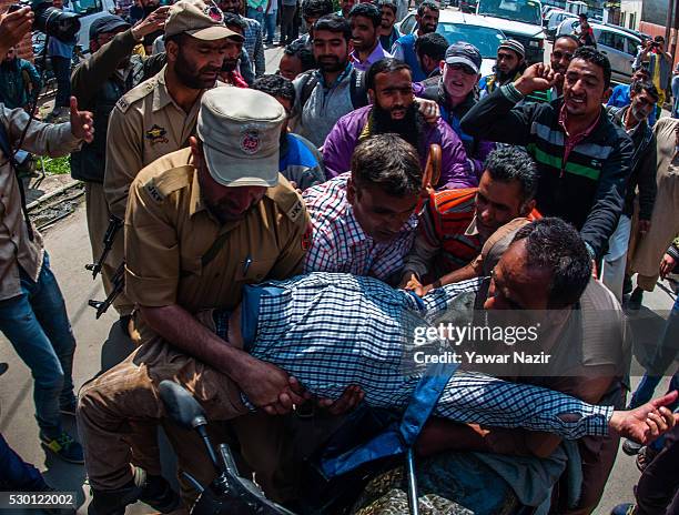 Indian Police detain a disabled member of All Jammu and Kashmir Handicapped Association shout anti government slogans during an anti government...