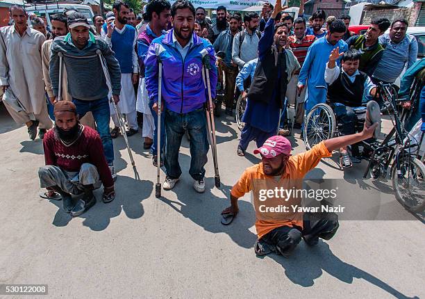 Kashmiri disabled members of All Jammu and Kashmir Handicapped Association shout anti government slogans during an anti government protest on May 10,...