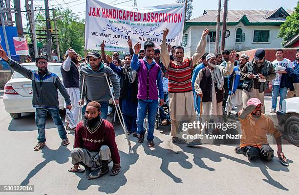 Kashmiri disabled members of All Jammu and Kashmir Handicapped Association shout anti government slogans during an anti government protest on May 10,...