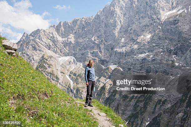 woman alone mountain path trekking summer - hiking across the karwendel mountain range stock pictures, royalty-free photos & images