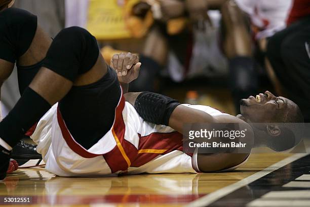 Dwyane Wade of the Miami Heat grimmices in pain as he lays on the court against the Detroit Pistons in Game Five of the Eastern Conference Finals...
