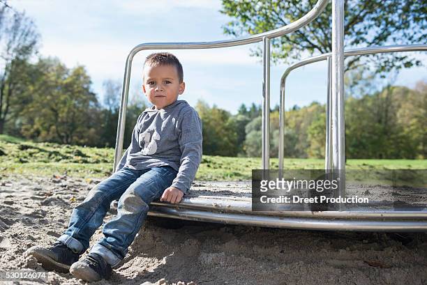 boy playground sitting portrait sand carousel - 2 boys 1 sandbox stock pictures, royalty-free photos & images
