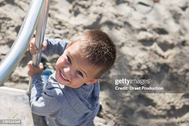 close up portrait small boy carousel playground - dreiviertelansicht stock pictures, royalty-free photos & images