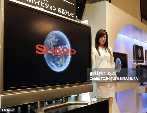 Model shows off the world's largest 65V-inch LCD Digital High-Definition flat TV, model "LC-65GE1", manufactured by Japan's Sharp Corporation during...