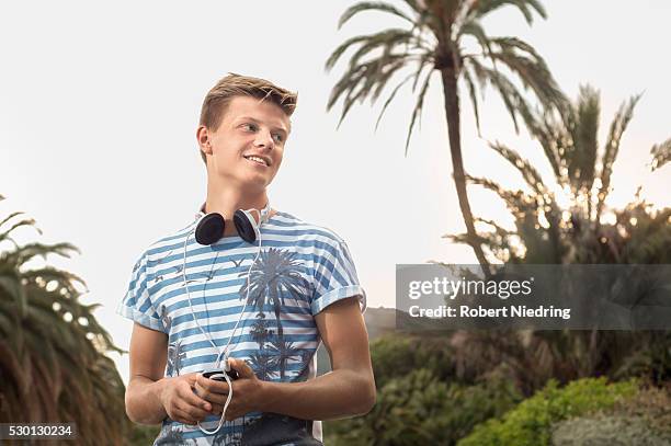 teenage boy headphones summer mp3 player - boy ipod stock pictures, royalty-free photos & images