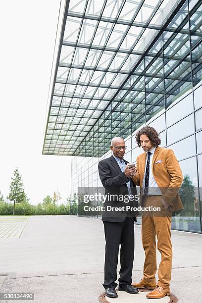 business colleague two men walking multiracial - präsentation layout stock-fotos und bilder