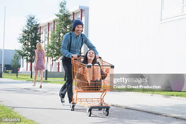 young man pretending to kidnap businesswoman - man pushing stock pictures, royalty-free photos & images