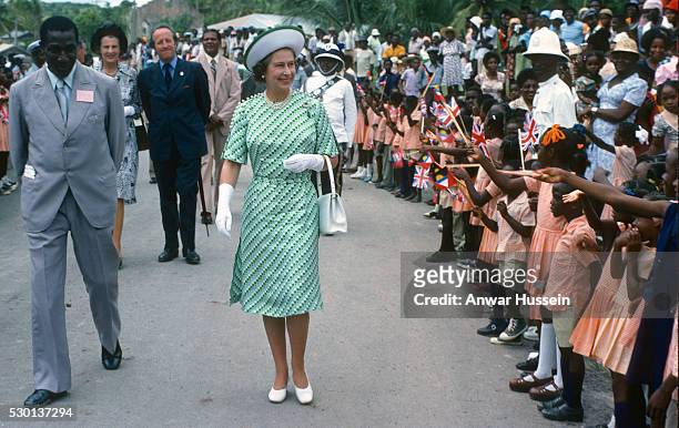 Queen Elizabeth ll is greeted by the public during a walkabout on November 01, 1977 in Antigua and Barbuda.
