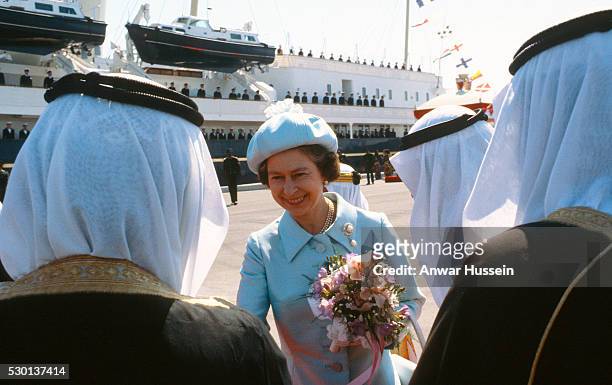 Queen Elizabeth ll is greeted by Arab nobility as she arrives in Bahrain on The Royal Yacht Britannia during a visit to the Gulf States on February...