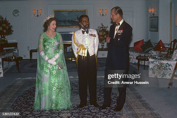 Queen Elizabeth ll and Prince Philip, Duke of Edinburgh entertain Sultan Qaboos on board the royal Yacht Britannia during a State Visit to Oman on...