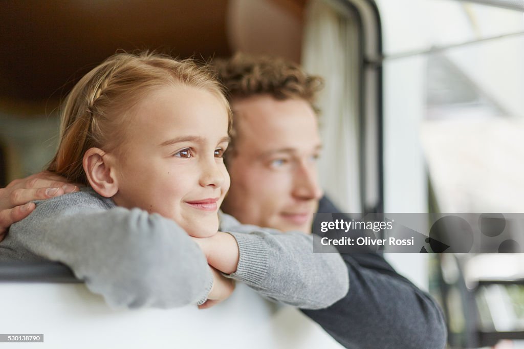 Happy father with daughter in a caravan