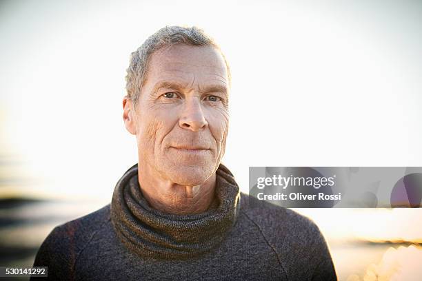 portrait of mature man on the beach - grey hair male stock pictures, royalty-free photos & images