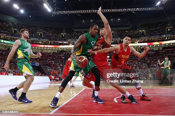 Mickell Gladness of Australia drives to the basket against Li Muhao of China during Internationl Basketball Challenge match between the Chinese...