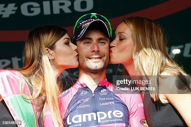 Italian cyclist Diego Ulissi of Lampre - Merida is kissed by hostesses as he celebrates on the podium after winning the fourth stage of 200 km from...